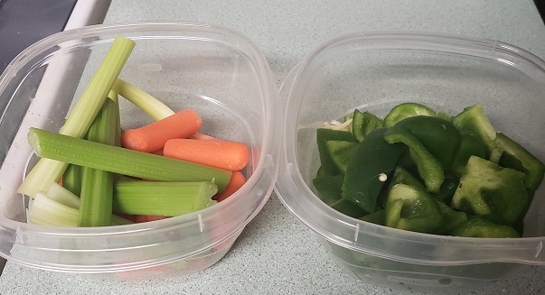 Picture of raw veggies in tupperware containers.