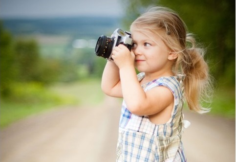 A picture of a little girl taking a picture. Taking snapshots of the day is a good practice of mindfulness.