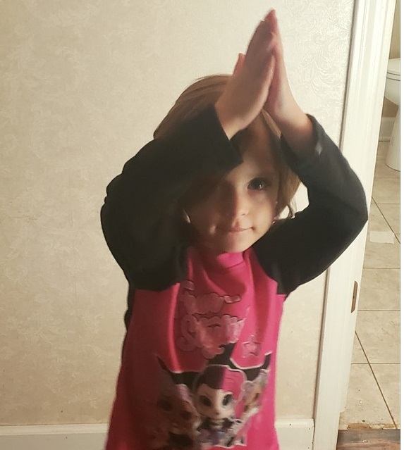 A picture of a child doing a tree pose. Yoga is a good way of practicing mindfulness.