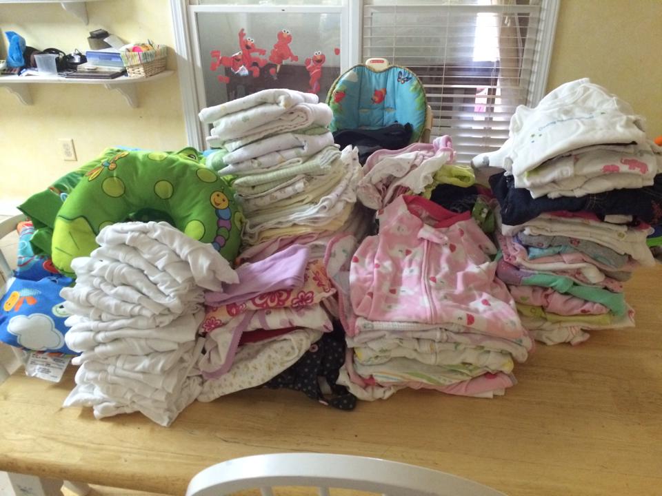 Picture of piles of clean baby laundry.