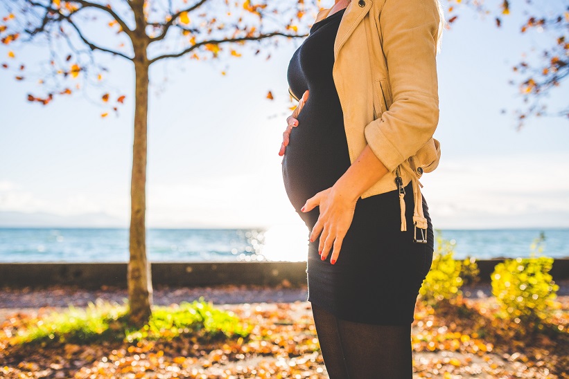 Picture of a pregnant woman holding her baby bump.